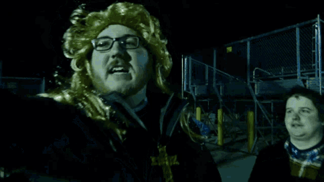 a man wearing a wig and glasses holds a flashlight in his hand