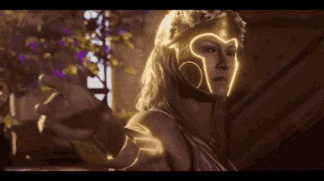 a woman wearing a helmet with a heart on it is standing in a dark room .