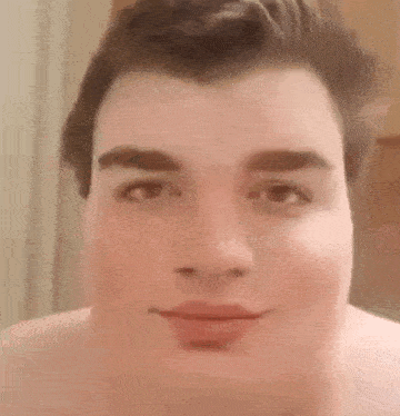 a close up of a man 's face without a shirt on .