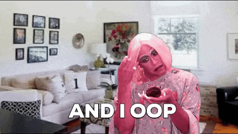 a woman in a pink wig is holding a cupcake and says " and i oop "