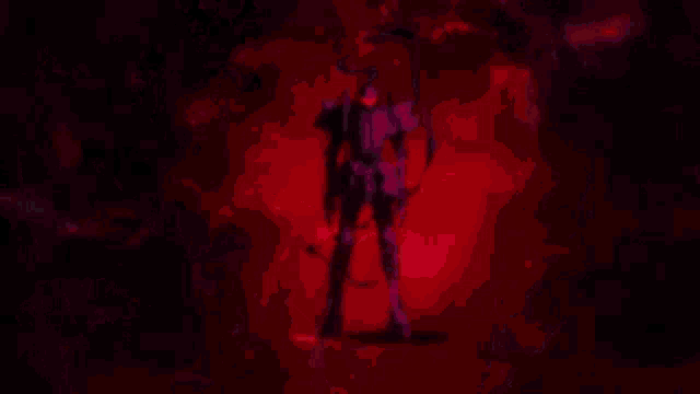 a close up of a person 's face in a dark room with red lights coming out of it .