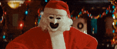 a man in a santa suit with a clown face on his face