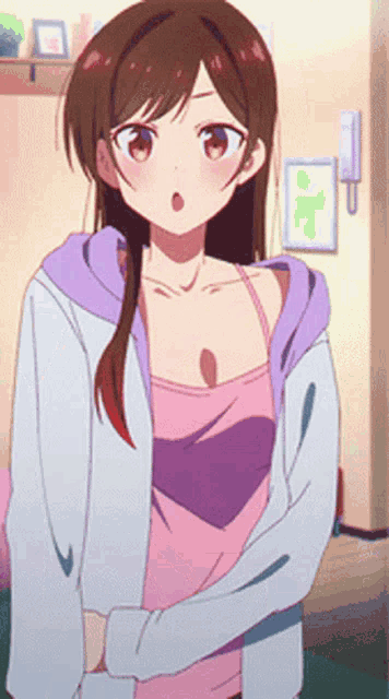 a girl in a pink tank top and a purple jacket is standing in a room .