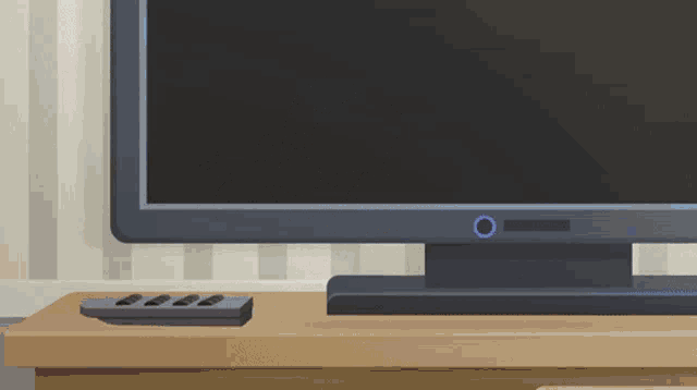a flat screen tv sits on a wooden shelf next to a remote