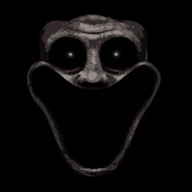 a close up of a scary face with a big smile on it 's face .