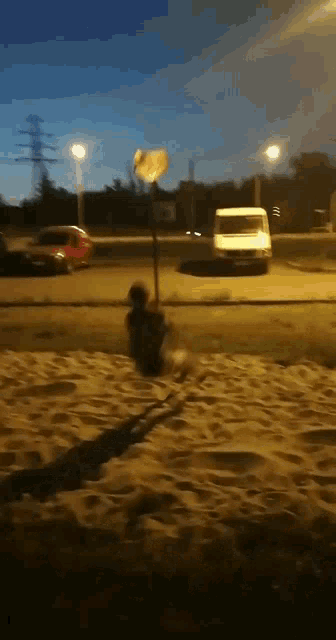a white van is parked on the side of a road at night