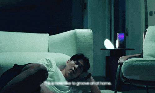 a man laying on the floor next to a couch with the words " this is how to groove at home " on the bottom