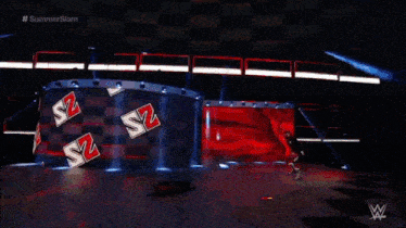 a person is standing on a stage in front of a sign that says s2 on it .