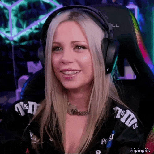 a woman wearing headphones and a jacket with m & m 's on it