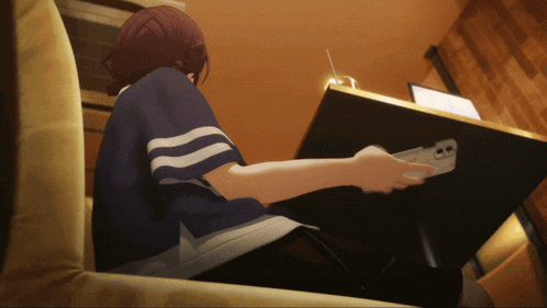 a girl is sitting on a couch playing a game
