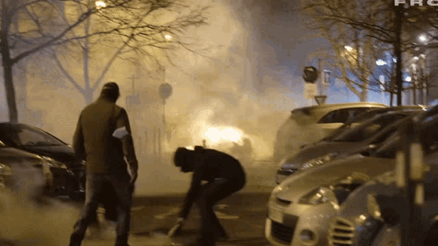 a group of people standing in a parking lot with smoke coming out of it and the word frc on the bottom