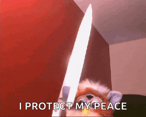 a furby holding a large knife with the words " i protect my peace " above it