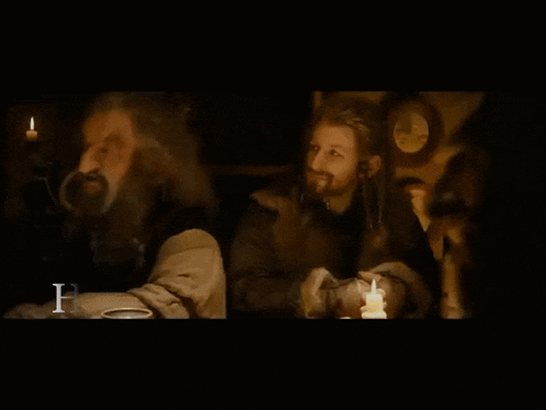 two men are sitting at a table with the words he said he 's an expert above them