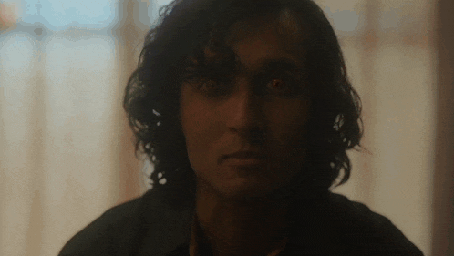 a close up of a man 's face with his eyes glowing red