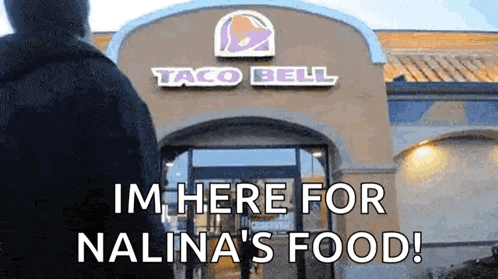a man is standing in front of a taco bell restaurant and says i 'm here for nalina 's food .