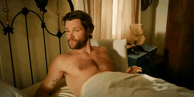 a shirtless man with a star tattoo on his chest