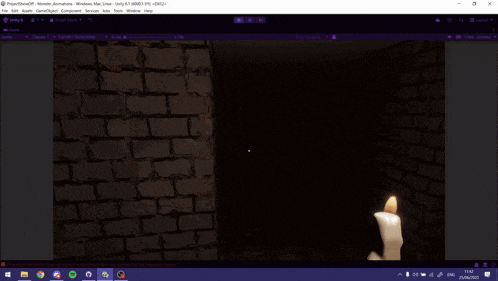 a computer screen shows a candle and a brick wall in the background