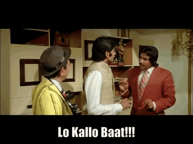 a man in a red suit is talking to two other men with the caption lo kallo baat