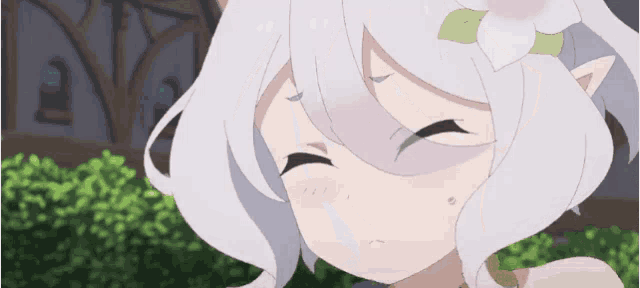 a girl with white hair and pink eyes is looking at the camera .