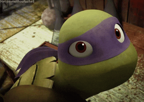 a teenage mutant ninja turtle with a purple headband on