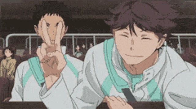 two anime characters are making a peace sign with their hands .