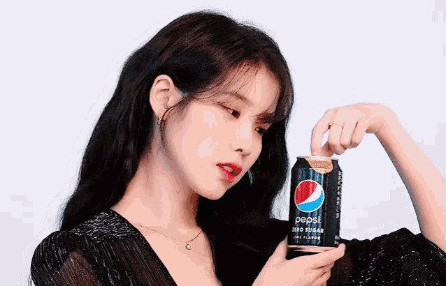 a woman holds a can of pepsi zero sugar