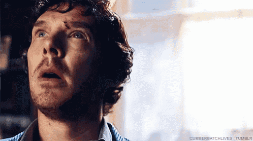 a close up of a man 's face with his mouth open and his eyes looking up .