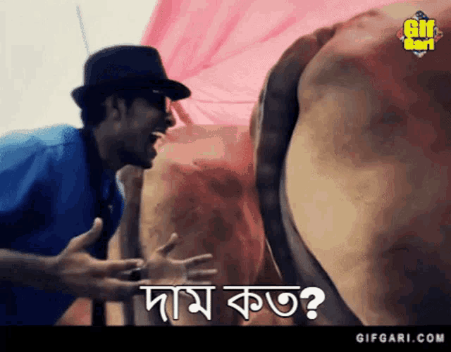 a man wearing a hat and sunglasses is standing next to a cow and says " dam kot " in a foreign language