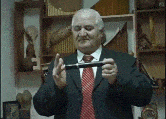 a man in a suit and tie is holding something in his hand