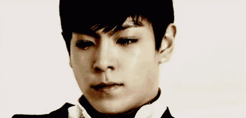 a close up of a young man 's face with a tear running down his cheek .