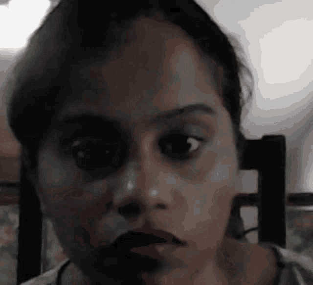 a close up of a woman 's face with a black eye