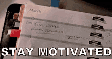 a spiral bound notebook with the words stay motivated written on it