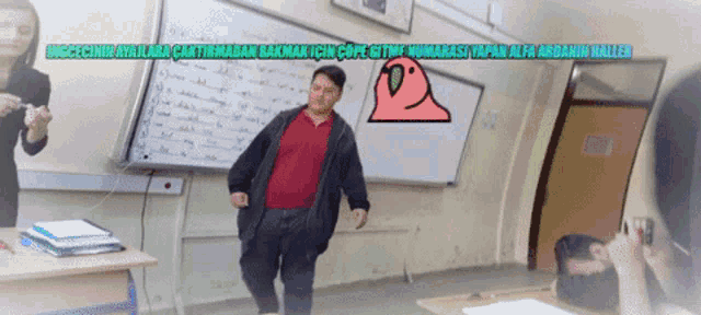 a man in a red shirt is standing in front of a white board with a cartoon drawing of a bird on it