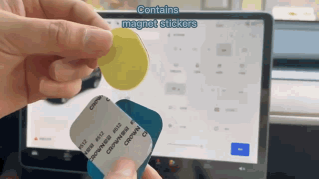 a person is holding a package of magnet stickers in front of a screen
