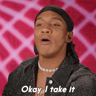 a man says okay i take it in front of a pink background