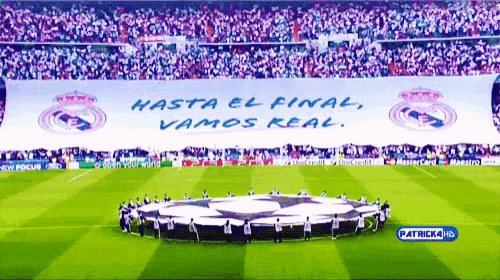 a soccer field with the words hasta el final vamos real on a banner