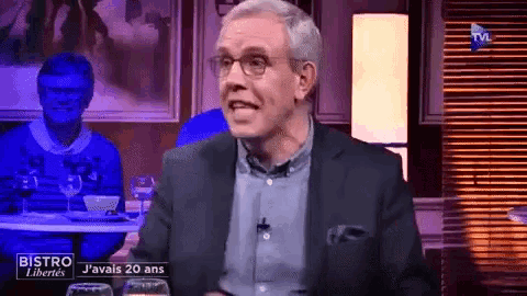 a man in a suit and glasses is on a television show called bistro j'avais 20 ans