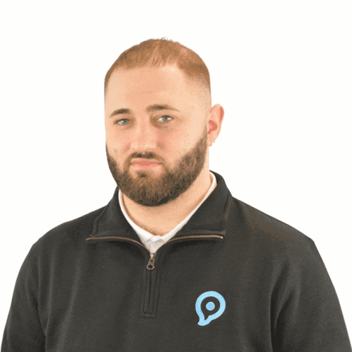 a man with a beard is wearing a black sweatshirt with a blue circle on the front
