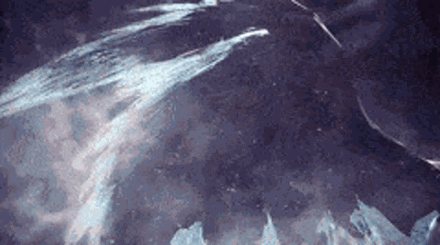 a close up of a purple background with a lot of smoke coming out of it