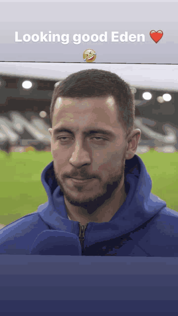a man wearing a blue hoodie with the words looking good eden on the bottom
