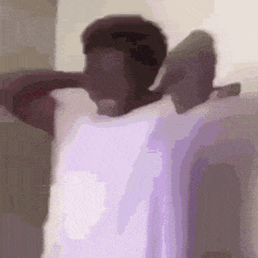 a man is wrapped in a purple towel with his arms outstretched .