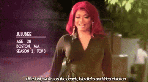 a drag queen with red hair is talking about walking on the beach .