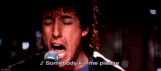 a man singing into a microphone with the words somebody kill me please