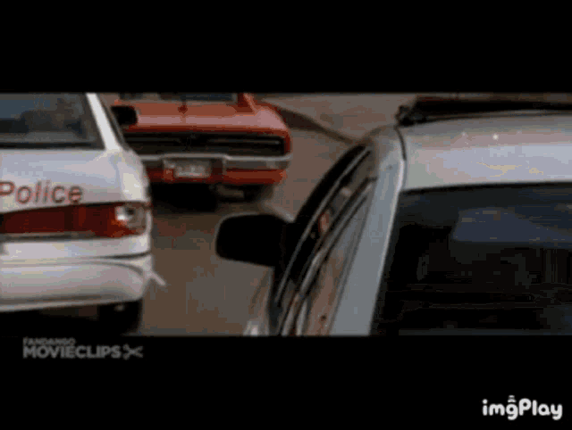 a group of police cars are driving down a street