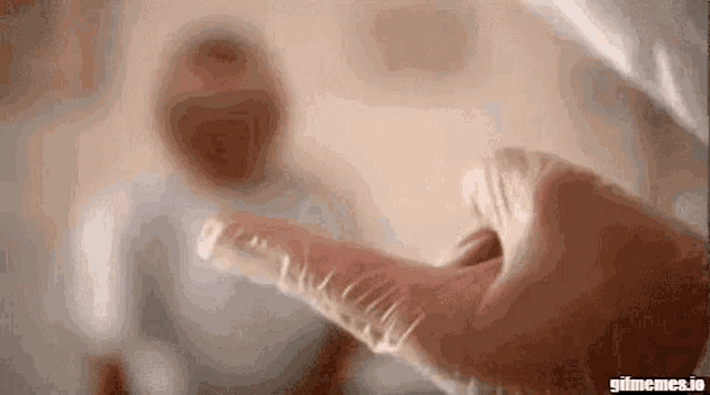a close up of a person 's hand holding a syringe with a needle in it .
