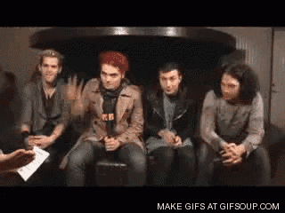 a group of men are sitting on a couch and talking to a woman .
