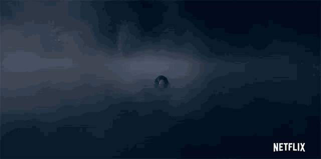 a netflix logo is displayed in a dark room