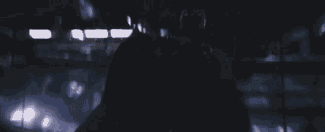 a person in a dark room with a blurred background .