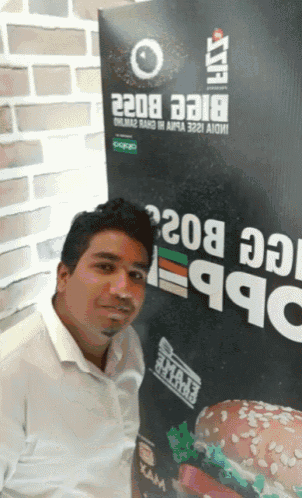 a man stands in front of a sign that says 2208 on it