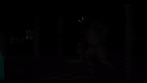 a teddy bear with glowing eyes is in the dark
